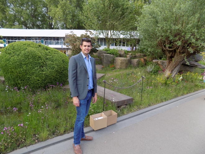 Looking dapper, Austin poses in front of a show garden at the 2015 RHS Chelsea Flower Show.